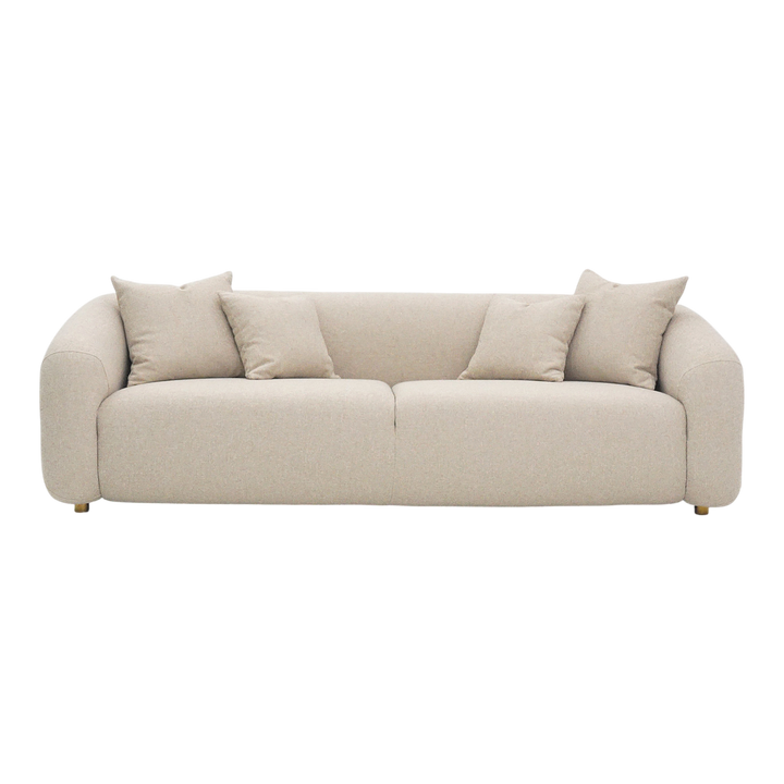 Three-seater Petra sofa in neutral fabric with plush cushions and wooden legs, ideal for modern living rooms.