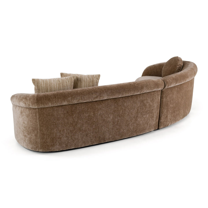 Curved Chiara sofa with plush fabric, modern design, and neutral color, perfect for stylish living room seating.