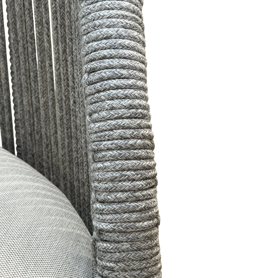 Gray Jardin outdoor arm chair with a cushioned seat and armrests, designed for comfortable outdoor lounging.