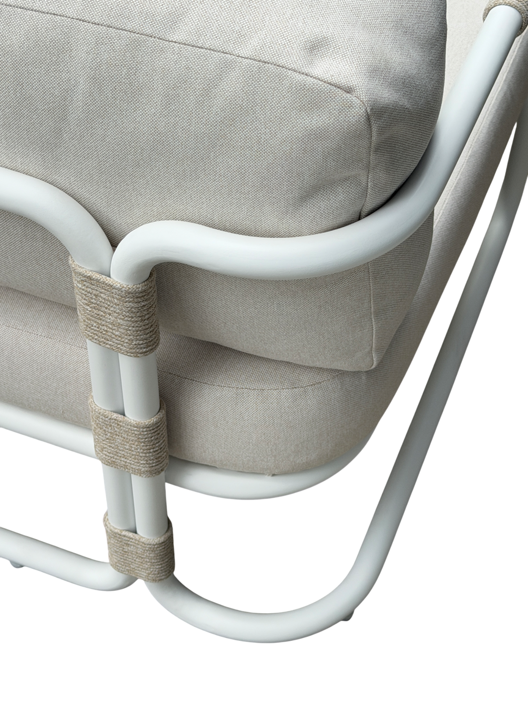 Cream-colored Fiore outdoor arm chair with a woven design, suitable for patio or garden seating, in a natural outdoor setting.