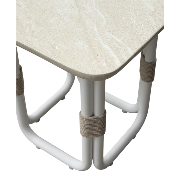 Cream-colored Fiore side table with a modern design, featuring a round top and slender legs, ideal for living room decor.