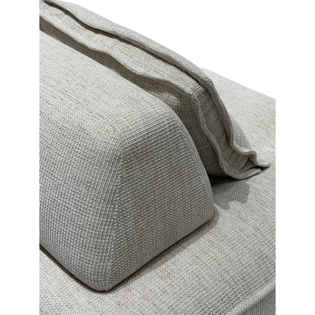 Cozy modular sofa with plush cushions and neutral fabric in a modern living room setting.