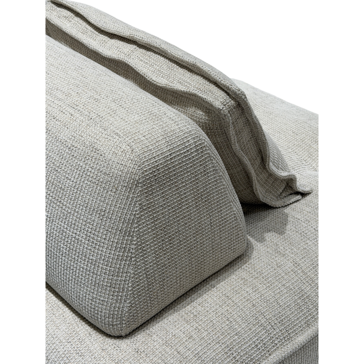 Cozy modular sofa with plush cushions and neutral fabric in a modern living room setting.