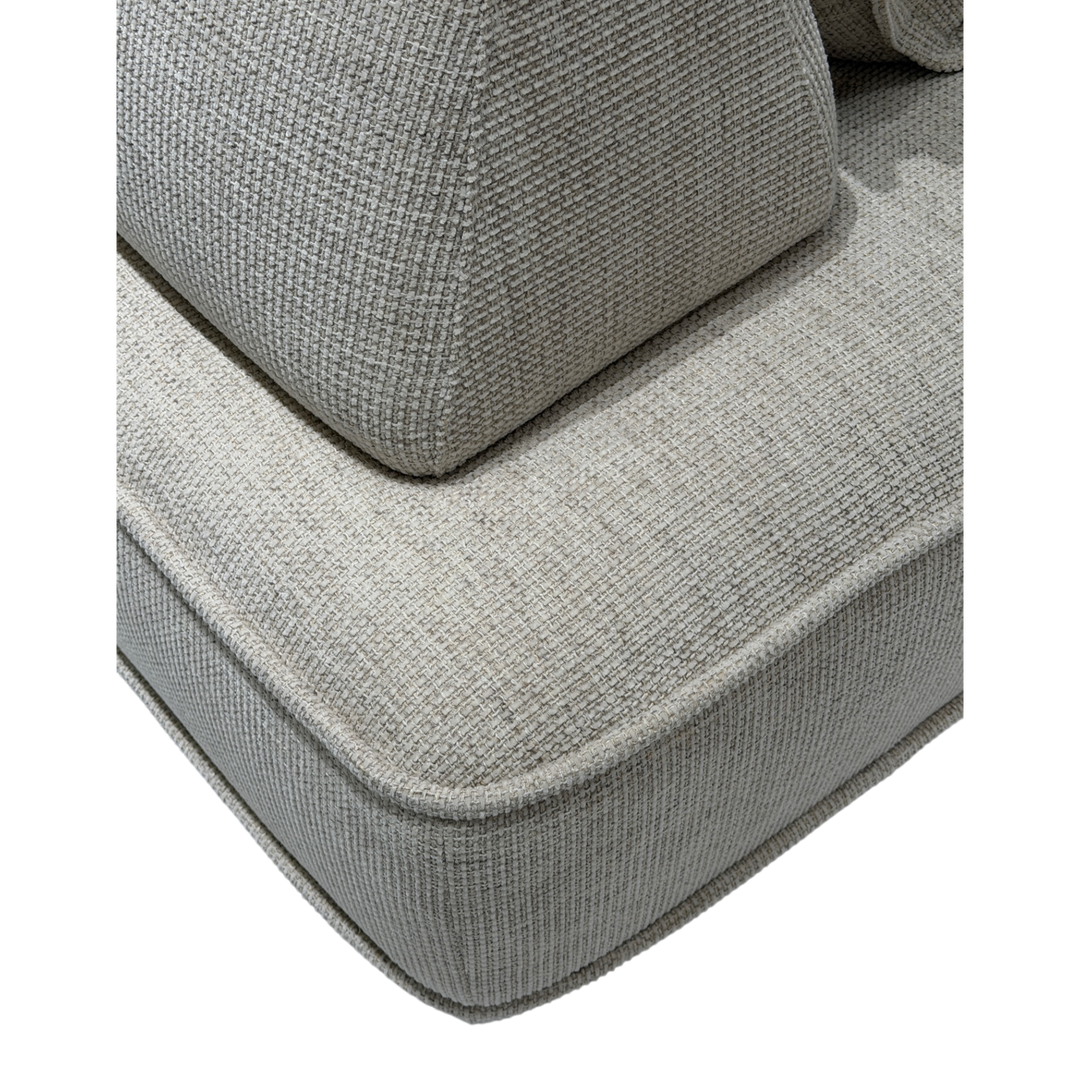 Cozy modular sofa with plush cushions and fabric upholstery, shown in a contemporary living room setting.