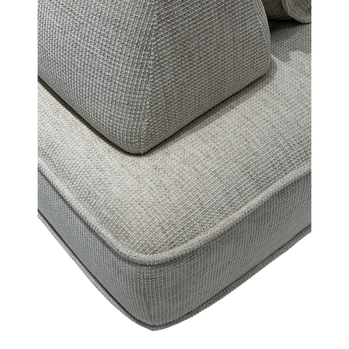 Cozy modular sofa with plush cushions and fabric upholstery, shown in a contemporary living room setting.