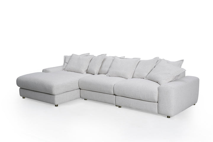 Corner sofa in beige fabric with plush cushions, Snuggy LHF sofa with modern design and wooden legs.