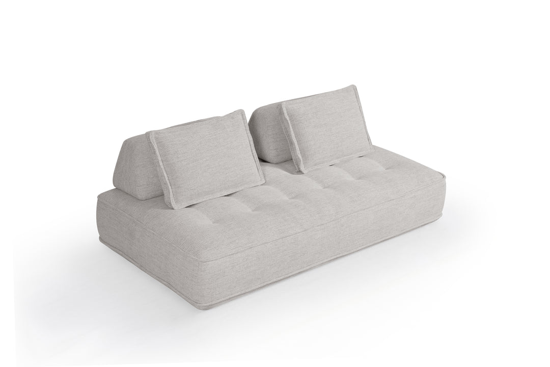 Cozy modular sofa in neutral fabric with plush cushions, designed for comfortable seating and versatile arrangement.