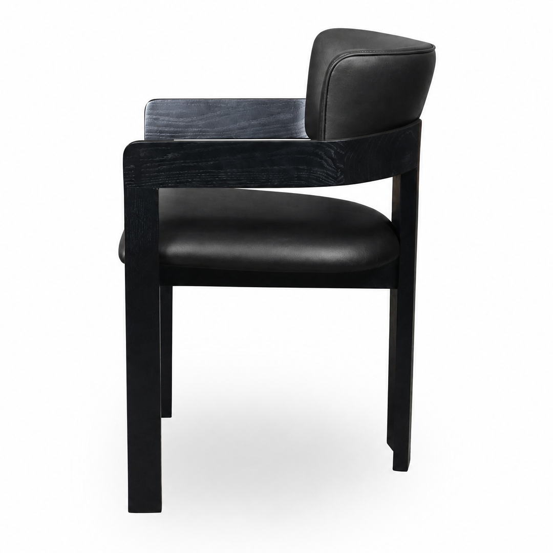 Black leather Maison dining chair with sleek modern design, featuring a comfortable cushioned seat and sturdy wooden legs.