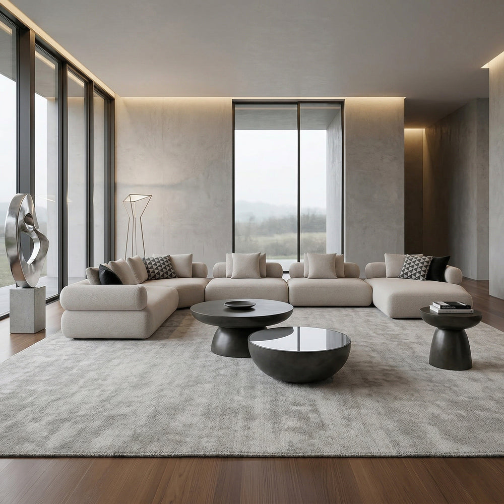 Large beige Grande sofa with plush cushions, paired with a modern coffee table in a contemporary living room setting.