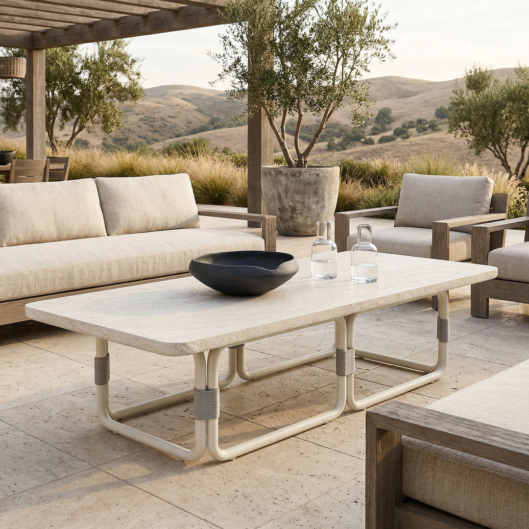 Outdoor patio with Fiore Coffee Table Creme, a stylish outdoor coffee table with a smooth, cream-colored surface and modern design.