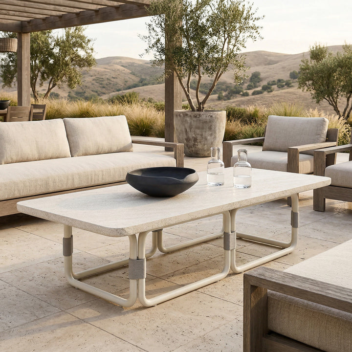 Outdoor patio with Fiore Coffee Table Creme, a stylish outdoor coffee table with a smooth, cream-colored surface and modern design.