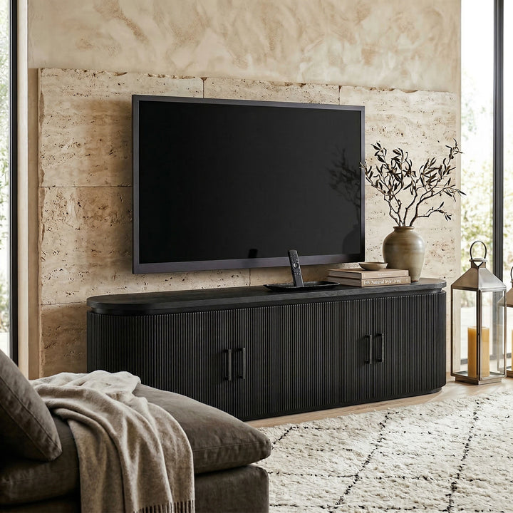 Modern Como TV unit placed against a wall with decorative accents, showcasing sleek design and storage space for entertainment setup.