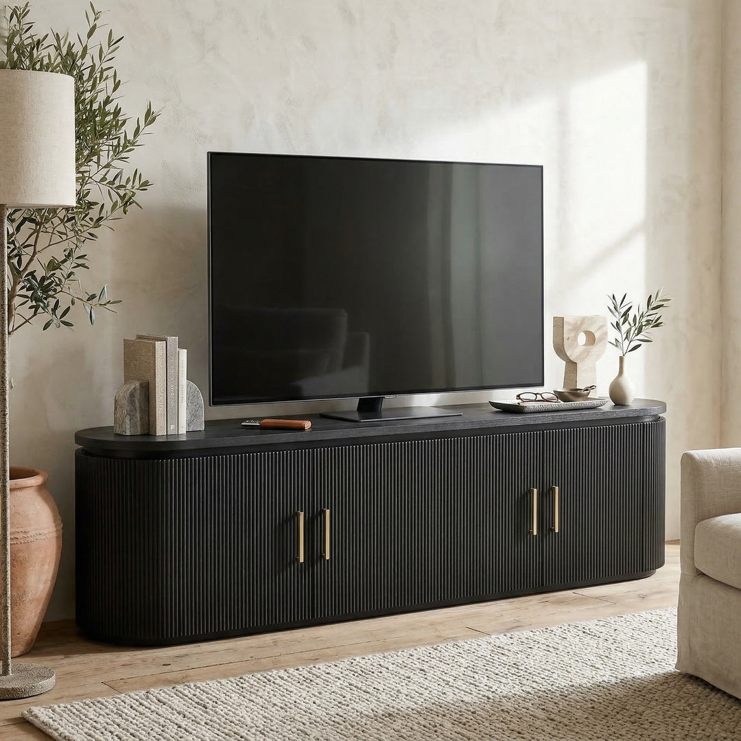 Modern Como TV unit placed against a wall with decorative accents, showcasing sleek design and ample storage for entertainment setup.