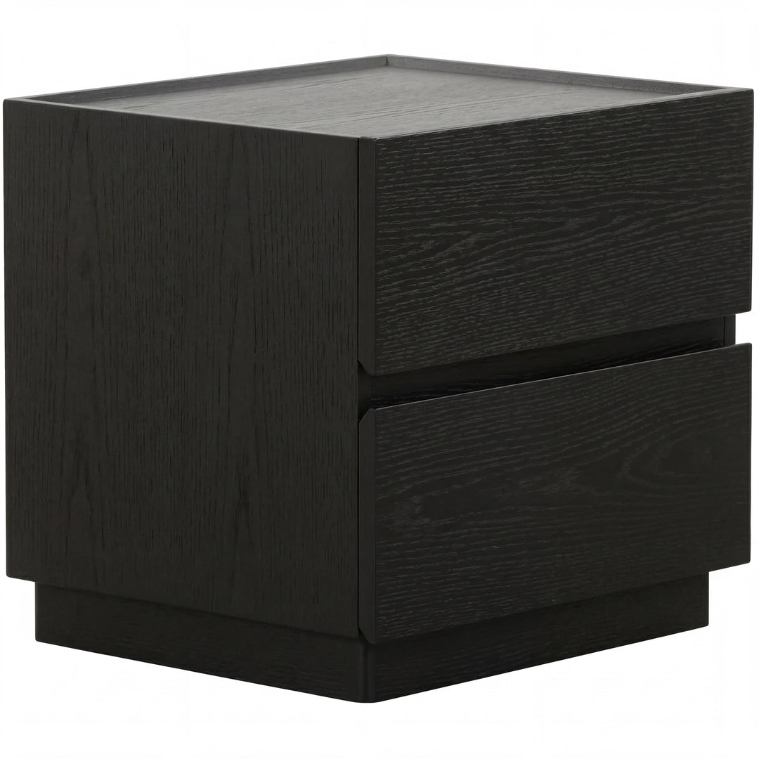 Black oak Madrid bedside table with a sleek, modern design, featuring a smooth surface and minimalist drawer handle.