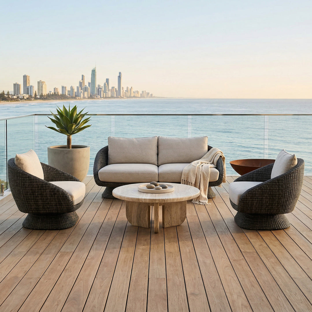 Grey outdoor sofa from Kipos with plush cushions, ideal for patio seating, shown on a travertine surface with outdoor furniture.