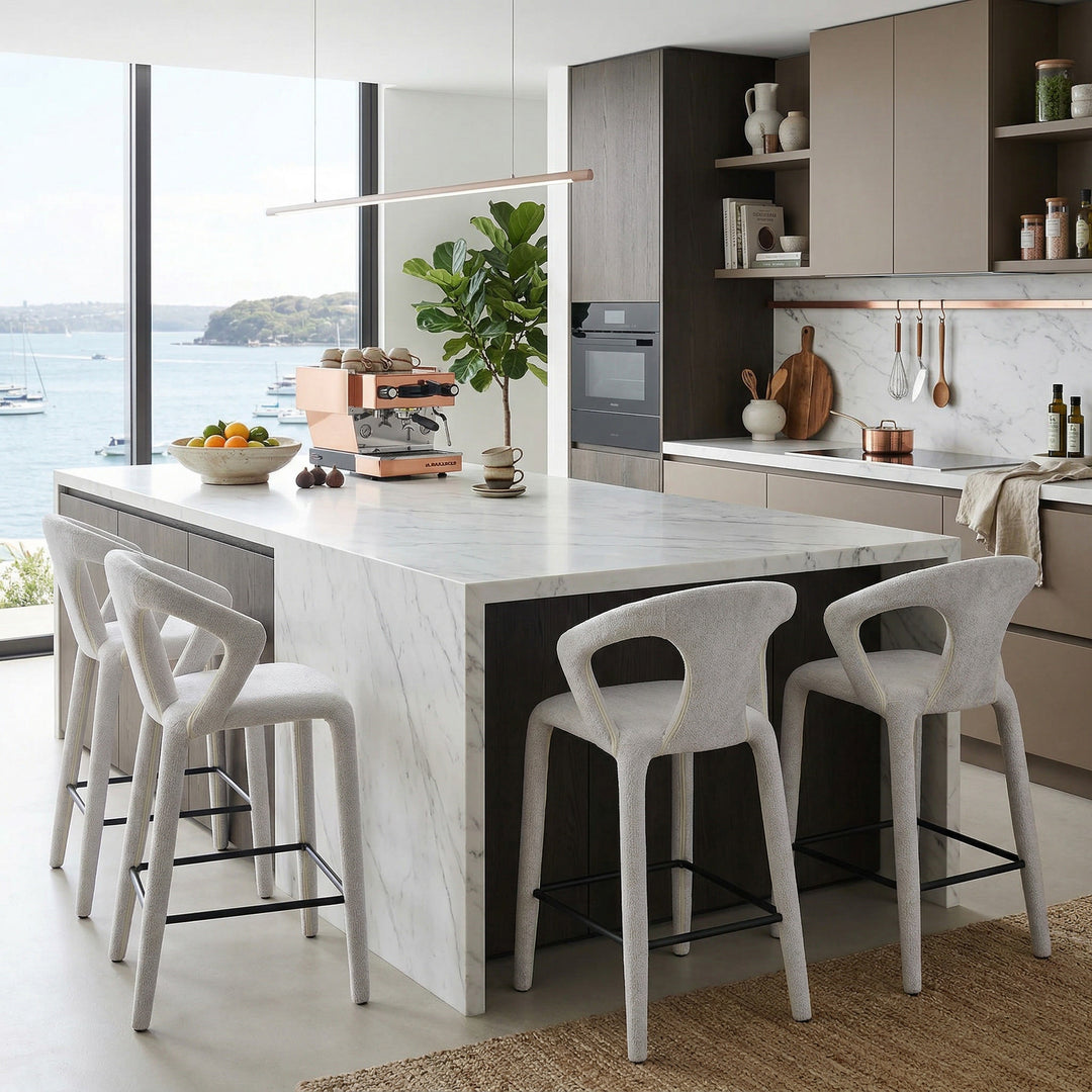 Modern beige textured profile bar stool with sleek design, featuring a curved seat and metal legs for contemporary kitchen seating.