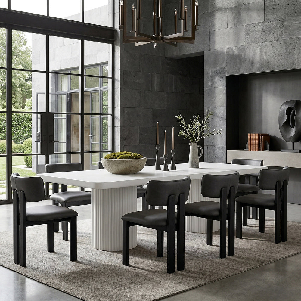 Black leather Modenese dining chair with a modern design, featuring a sleek, cushioned seat and stylish wooden legs.