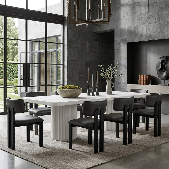 Black leather Modenese dining chair with sleek design, featuring a cushioned seat and modern style, ideal for contemporary dining rooms.
