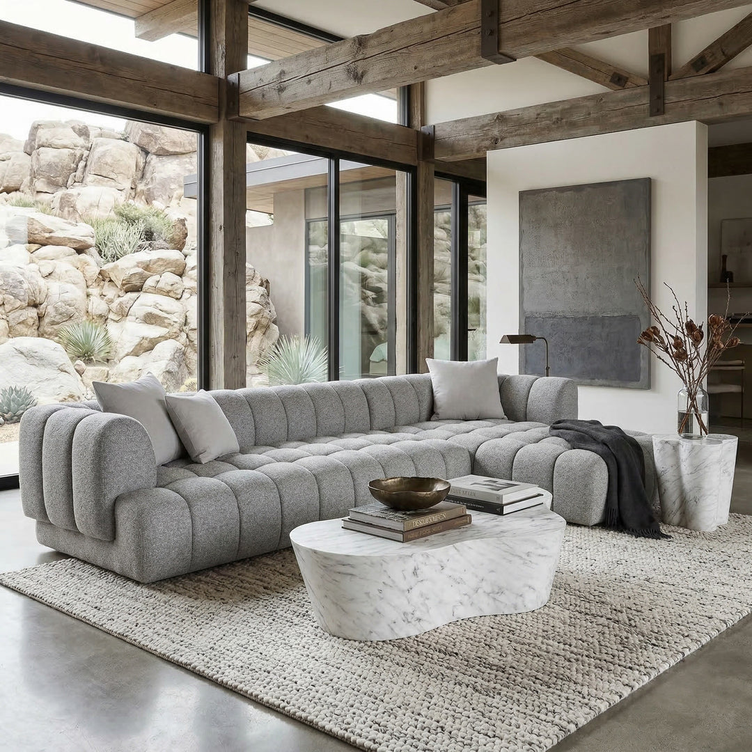Modern gray corner sofa in a contemporary living room, featuring clean lines and plush cushions for comfortable seating.