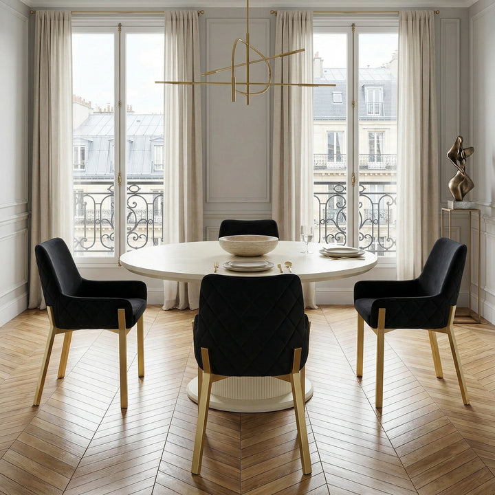 Round Vellar dining table, 1.3m, with a smooth wooden surface and sturdy legs, set for four in a modern dining room.