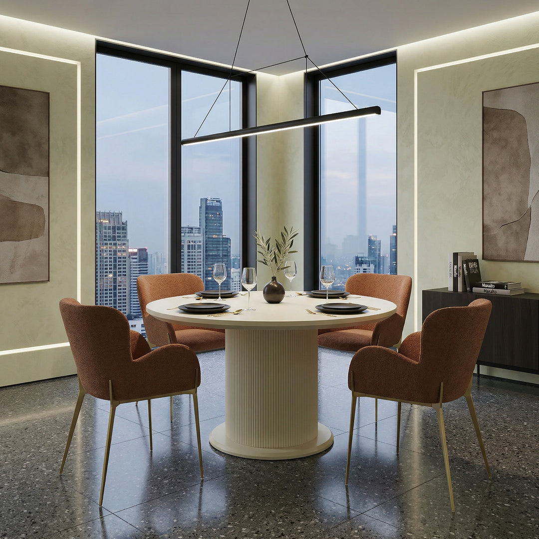 Round Vellar dining table, 1.3m, with a wooden surface, shown with four matching chairs in a modern dining room setting.