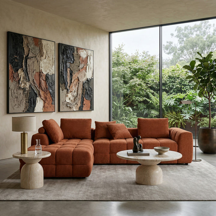Rust-colored Cuddly Modular Sofa LHF with plush cushions, shown with a coffee and side table in a modern living room setting.