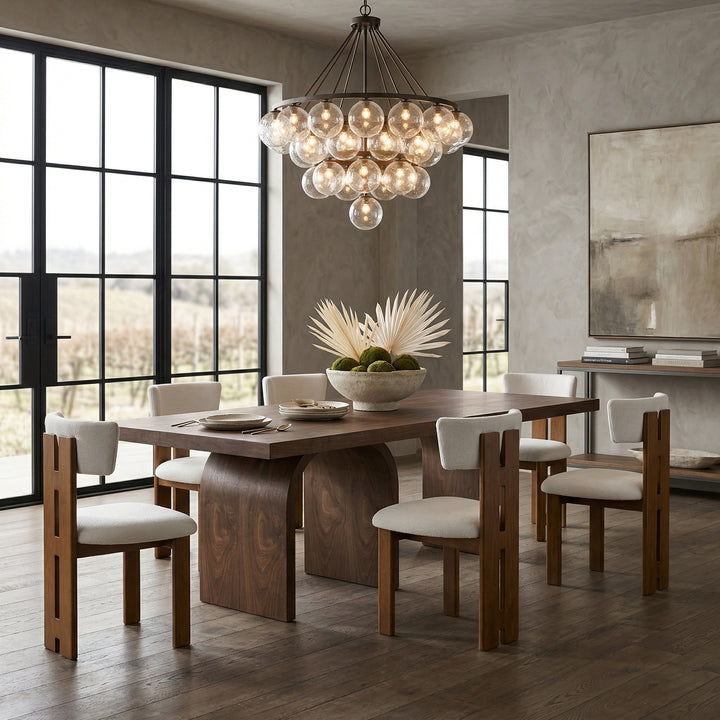 Beige Carlita dining chair with a sleek design and wooden legs, shown in a modern dining room setting.
