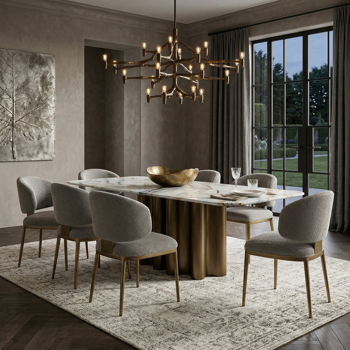 Elegant Regalia dining chair with plush upholstery and wooden legs, paired with a matching dining table in a luxurious setting.