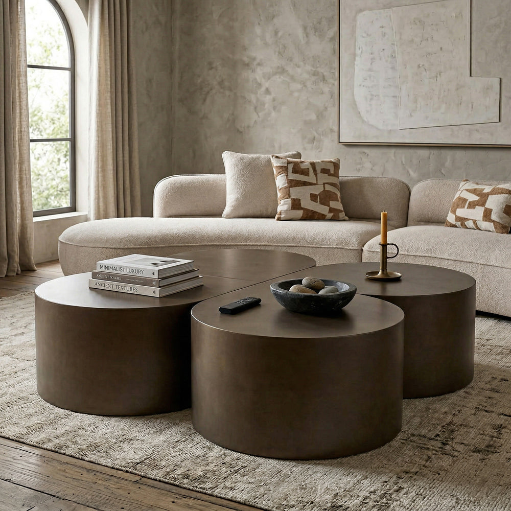 Dark bronze tear drop coffee table in a modern living room setting with a sofa and other furniture.