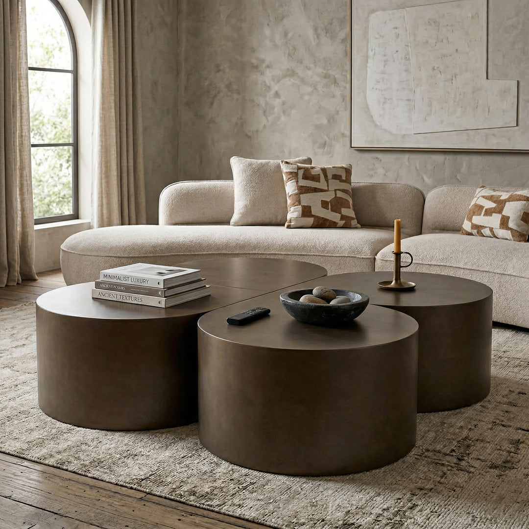 Dark bronze tear drop coffee table in a modern living room setting with a sofa and other furniture.