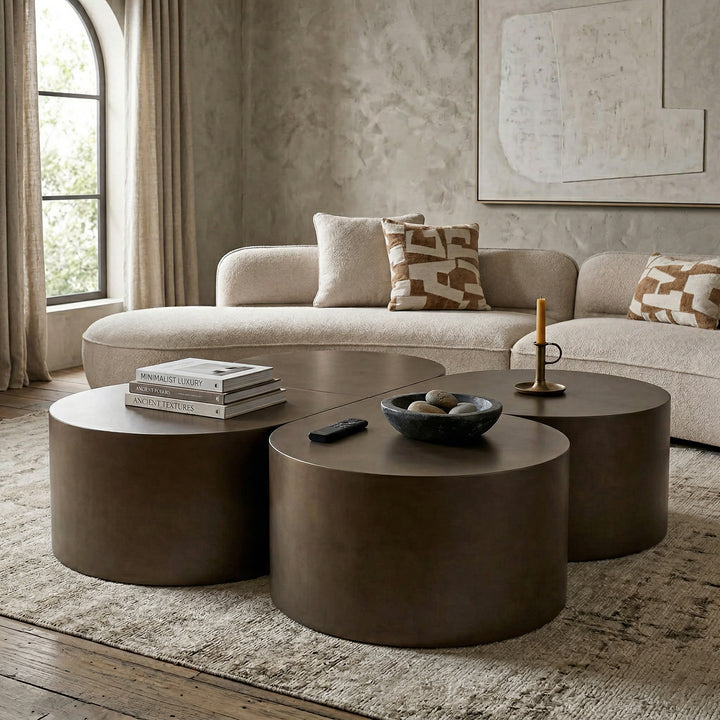 Dark bronze tear drop coffee table in a modern living room setting with a sofa and other furniture.