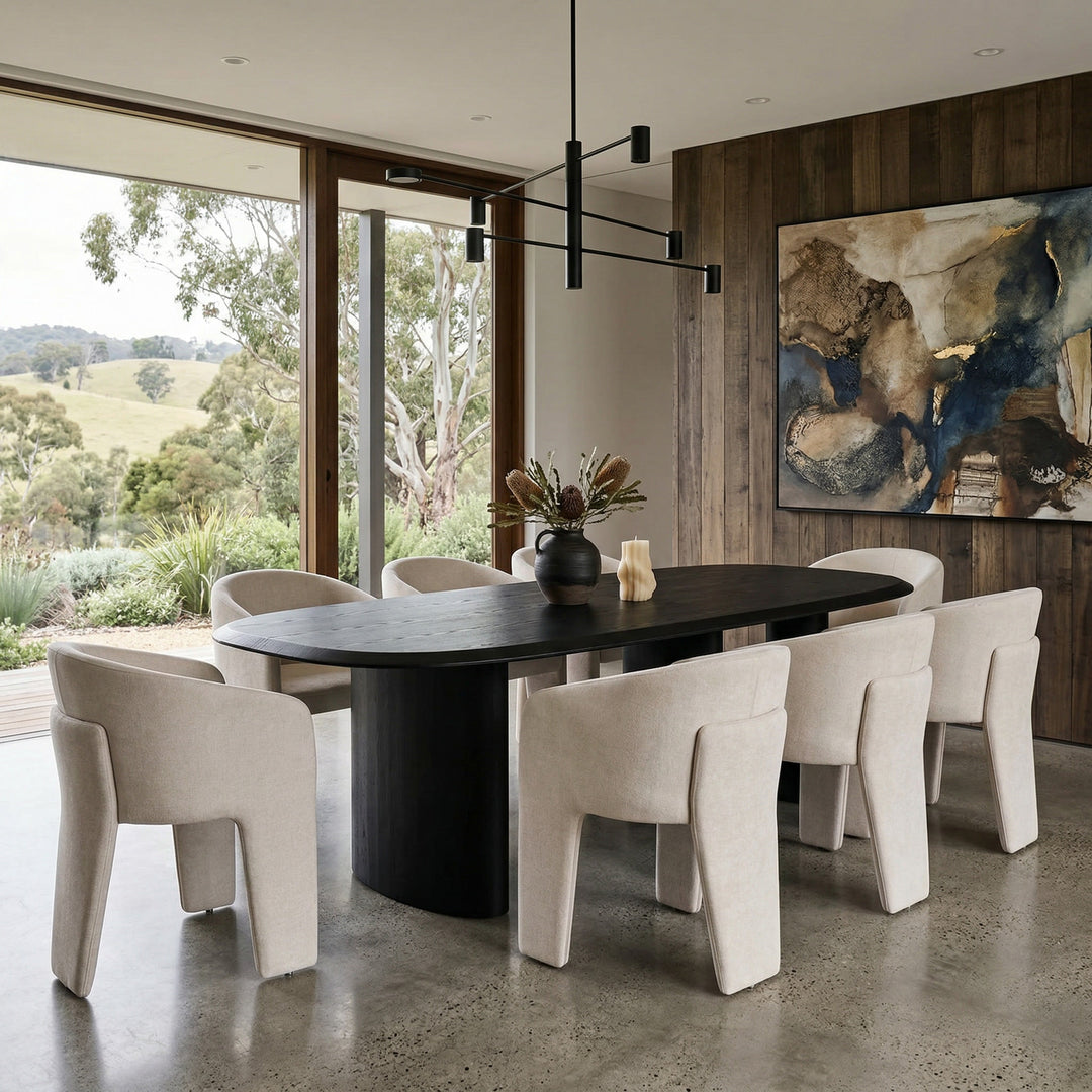 Black dining table with a nano-banana design, paired with a Crema Isabella dining chair, showcasing modern dining room furniture.