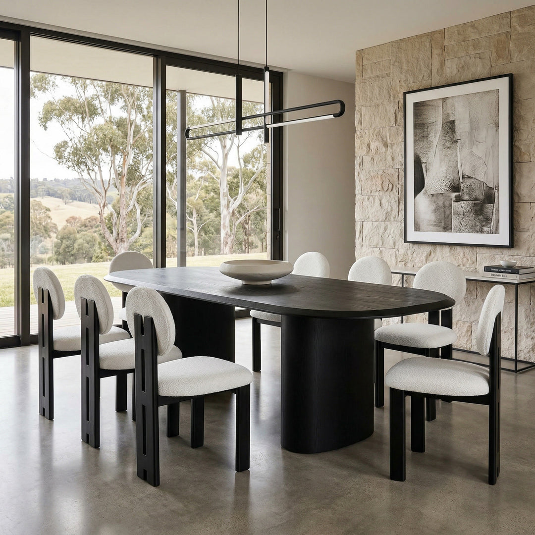 Beige Yarra dining chair with a modern design, shown next to a black dining table in a contemporary dining room setting.