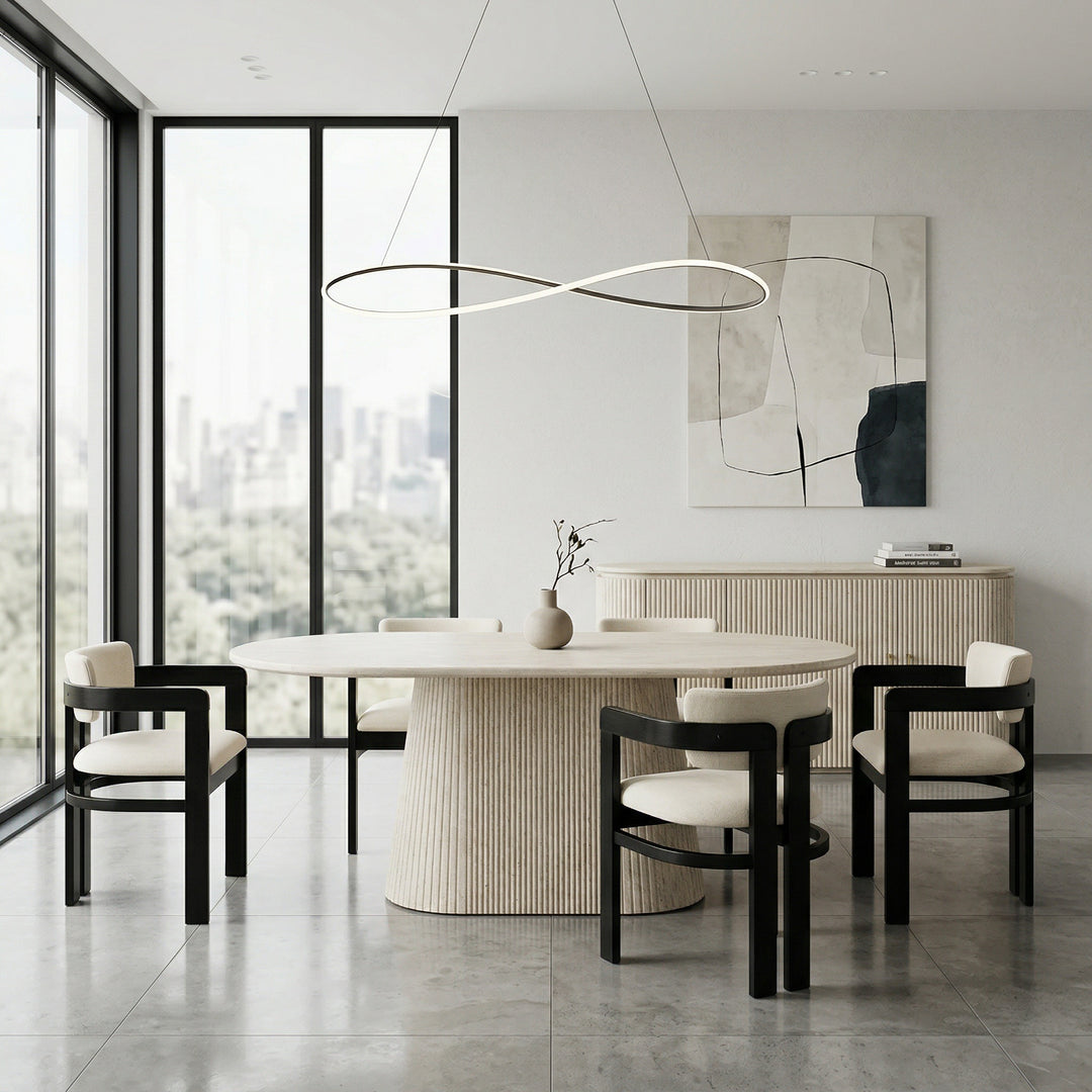 Beige Calabria dining chair with a sleek design, positioned next to a travertine dining table and buffet in a modern dining room.