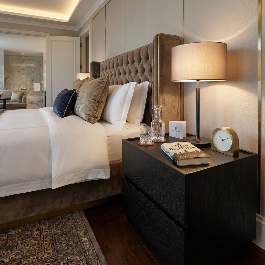 Black oak Madrid bedside table with a sleek design, placed in a modern bedroom setting.