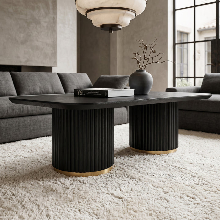 Black wood Mirabella coffee table with sleek flitted legs and brushed gold accents, modern design for living room decor.