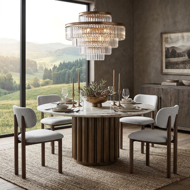 Round marble-top dining table with sleek legs, suitable for modern dining rooms.