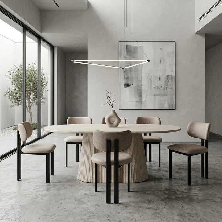 Stone leather look Farinelli dining chair with sleek design, shown alongside a dining table in a modern kitchen setting.