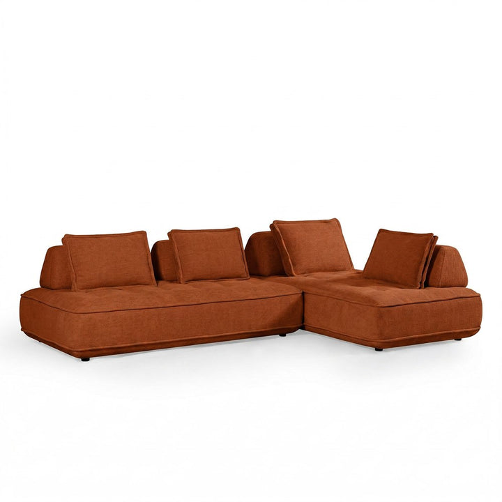Rust-colored modular sofa with plush cushions and contemporary design, featuring a cozy, inviting fabric for living room decor.