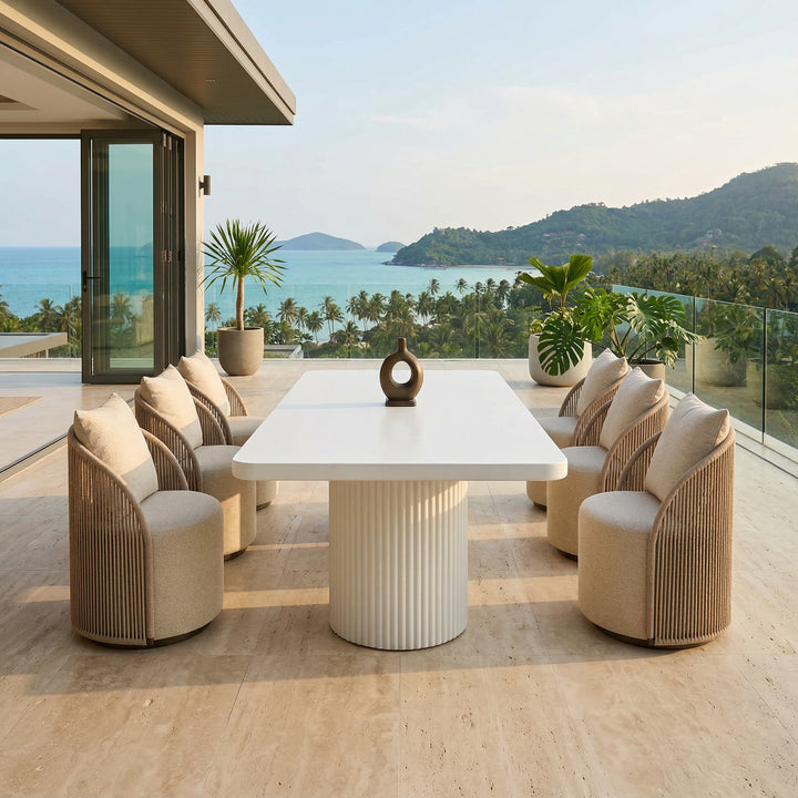 White Jardin outdoor dining chair from the Dune collection, shown alongside a rectangular outdoor dining table.