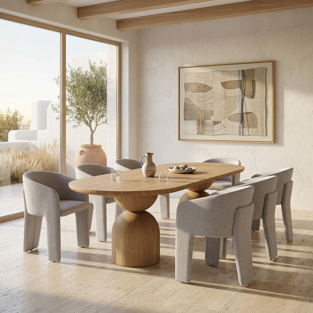 Beige Isabella dining chair with wooden legs, placed next to a large oak dining table in a modern dining room setting.