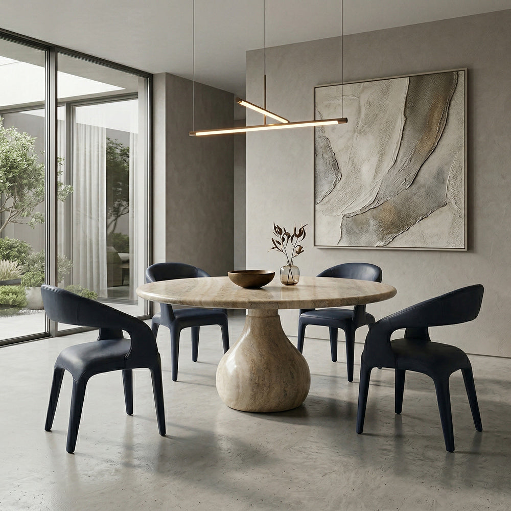 Black leather look Lorenzo dining chair with sleek design, shown alongside a travertine round dining table.