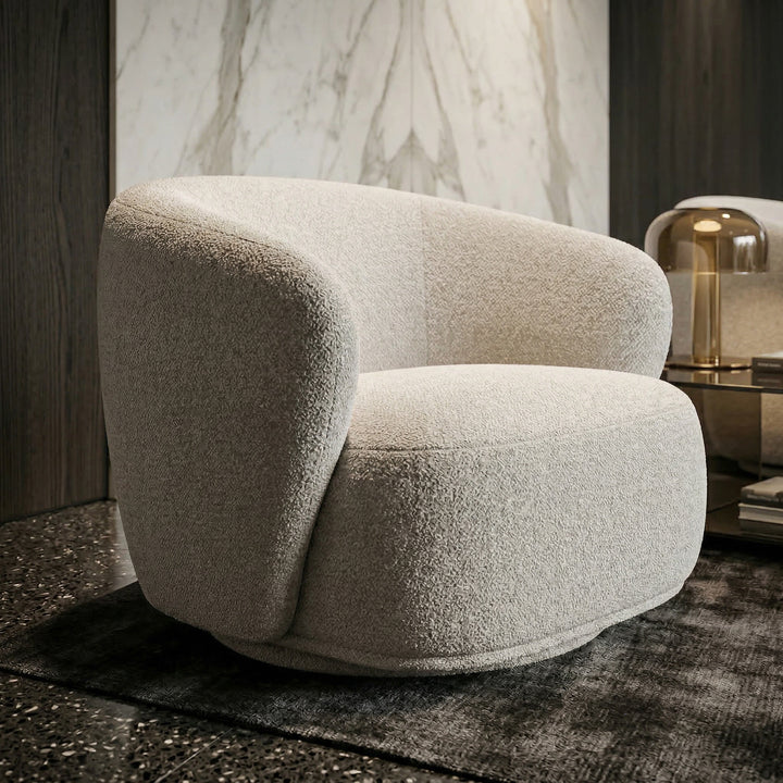 White Bianco swivel chair with rounded design in a modern living room setting, featuring a cozy and stylish appearance.