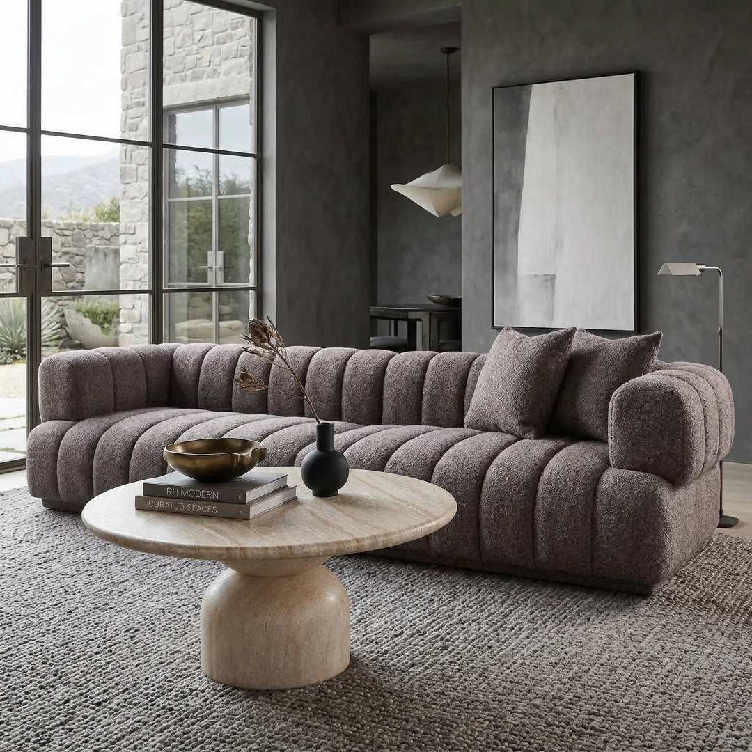 Modern Sardinia 4-seater sofa in neutral fabric, shown in a contemporary living room setting with clean lines and plush cushions.