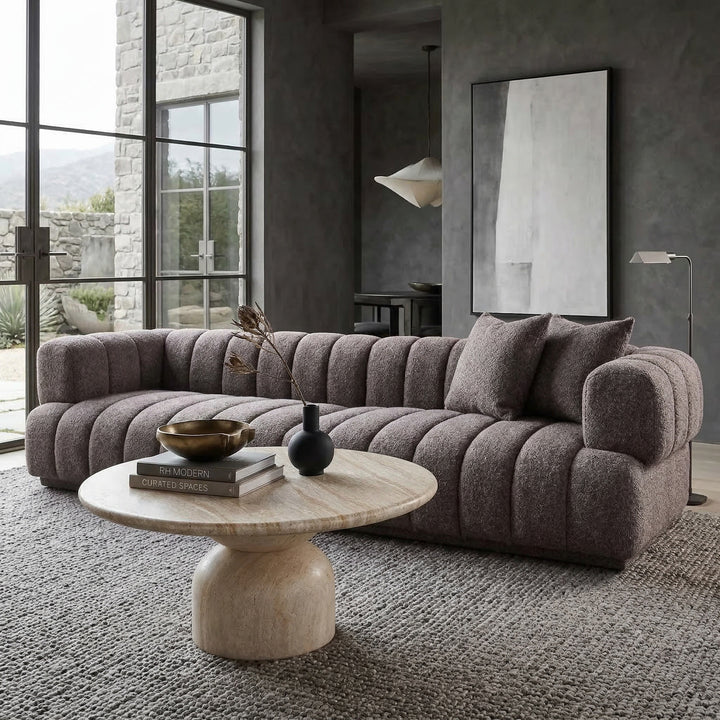 Modern Sardinia 4-seater sofa in neutral fabric, shown in a contemporary living room setting with clean lines and plush cushions.