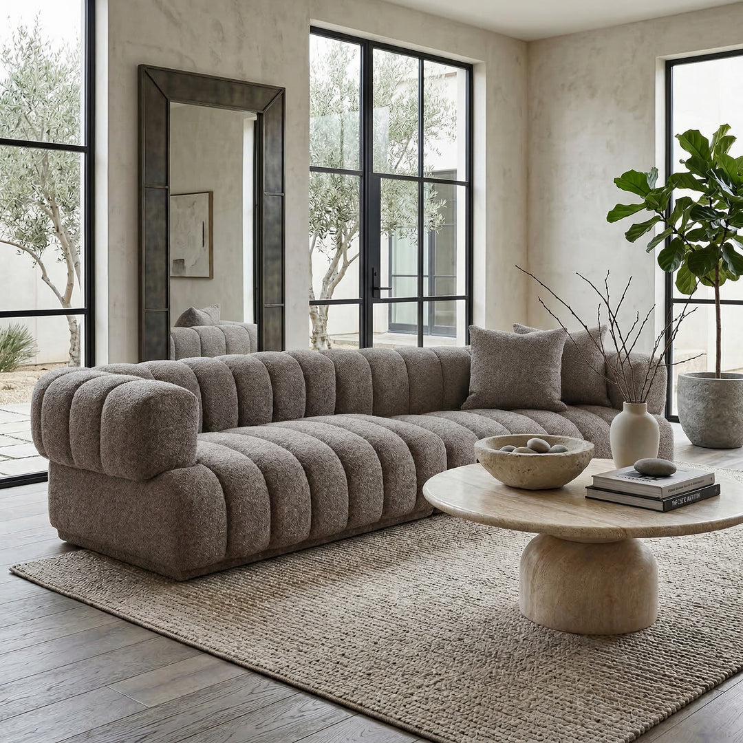 Modern Sardinia 4-seater sofa in neutral fabric, shown in a stylish living room setting with clean lines and plush cushions.