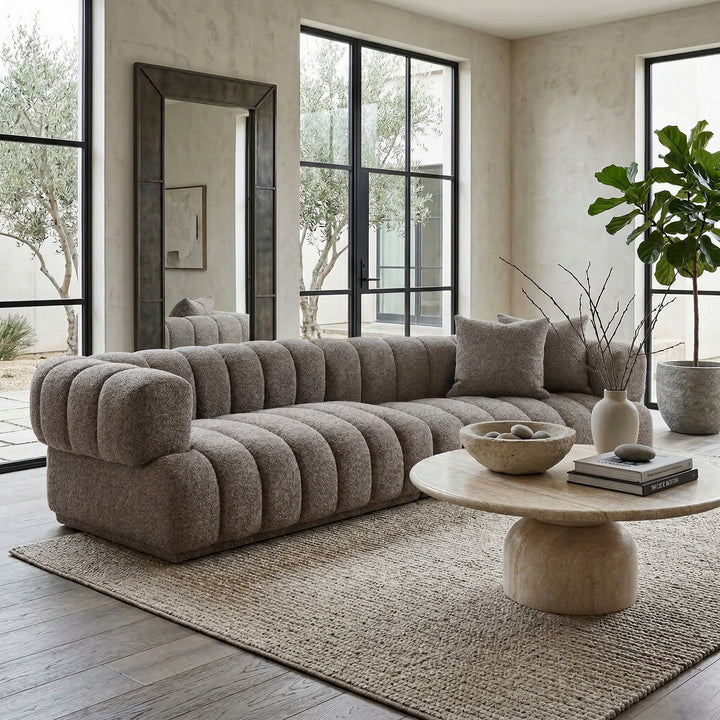 Modern Sardinia 4-seater sofa in neutral fabric, shown in a stylish living room setting with clean lines and plush cushions.