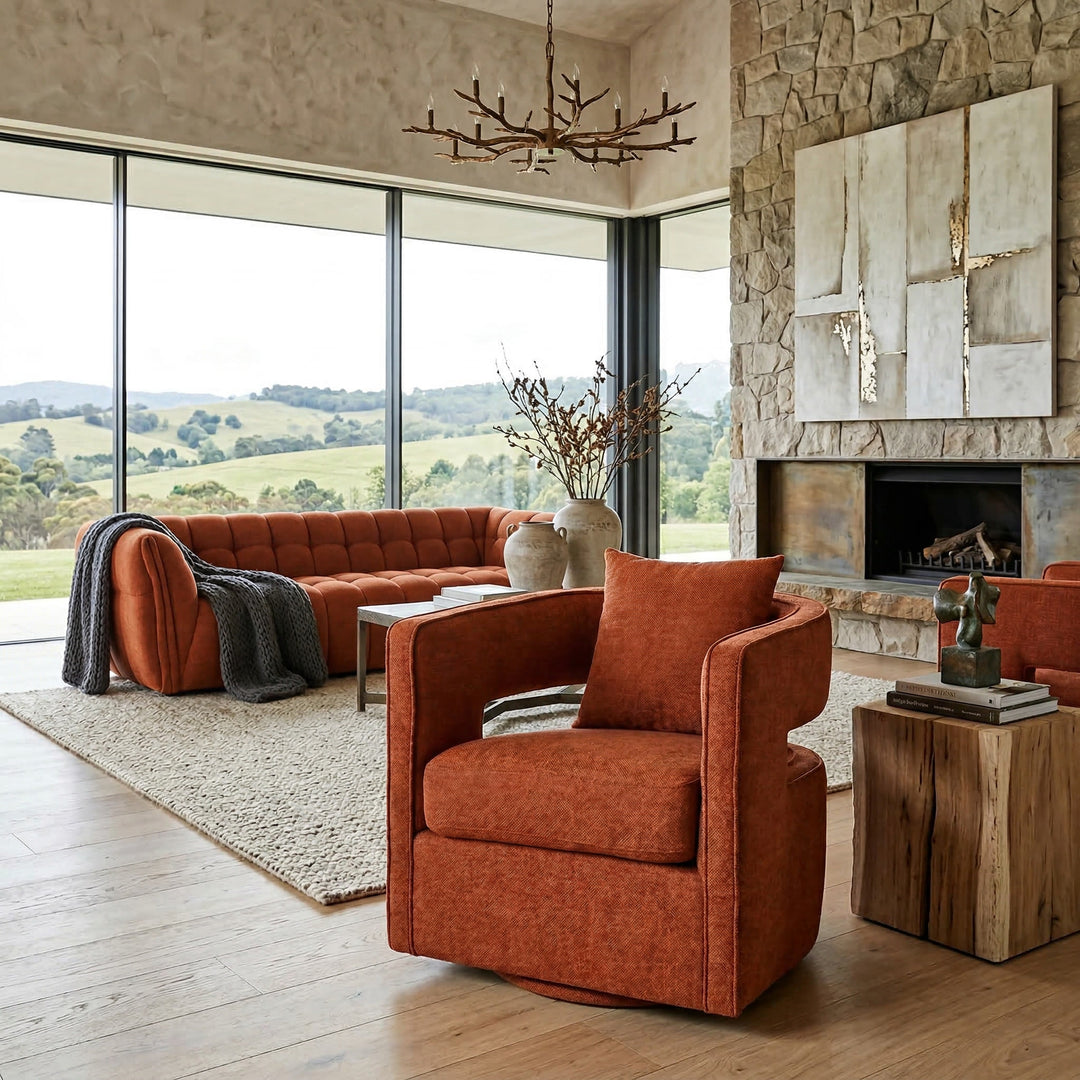 Rust-colored Rhonda swivel chair with modern design, featuring a rounded seat and sleek metal base in a contemporary living room setting.