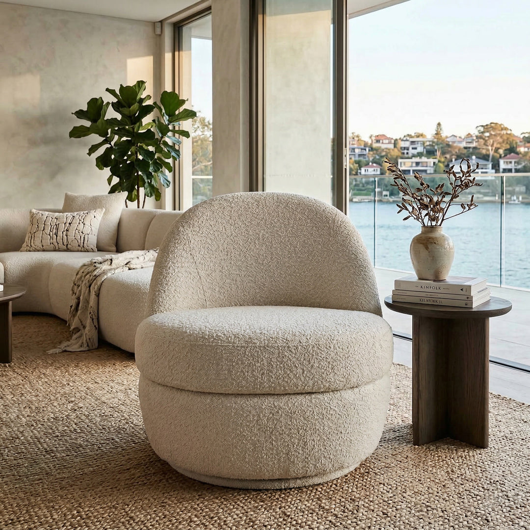 Modern Lusso Swivel Chair with a rounded banana-shaped design, featuring a sleek fabric upholstery and a swivel base.