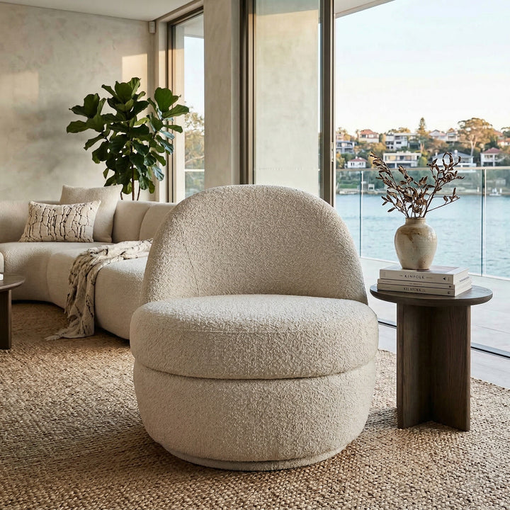 Modern Lusso Swivel Chair with a rounded banana-shaped design, featuring a sleek fabric upholstery and a swivel base.